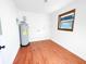 Bright utility room features a water heater and durable wooden flooring at 144 Morning Creek Rd, Jonesboro, GA 30238