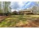 An expansive backyard with a playset, covered patio, and landscaped surroundings, great for outdoor activities at 2251 Everleigh Ln, Marietta, GA 30064