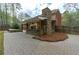This backyard features a stone fireplace, outdoor kitchen, and spa providing a perfect outdoor living space at 2251 Everleigh Ln, Marietta, GA 30064
