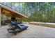 A backyard featuring a covered patio with a grill, dining area, hot tub and lounge chairs at 2251 Everleigh Ln, Marietta, GA 30064