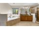 Bathroom featuring a soaking tub, granite countertops, and natural light at 2251 Everleigh Ln, Marietta, GA 30064