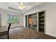 Bright bedroom featuring a ceiling fan, a window overlooking the trees, and an open closet with shelves at 2251 Everleigh Ln, Marietta, GA 30064