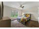 Bedroom showcases neutral walls, carpet, an oversized window, and ceiling fan for comfort at 2251 Everleigh Ln, Marietta, GA 30064