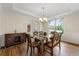 Formal dining room featuring hardwood floors, a stylish chandelier, and a view of the backyard at 2251 Everleigh Ln, Marietta, GA 30064