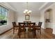 Bright dining room with hardwood floors, tray ceiling, and large window overlooking a backyard at 2251 Everleigh Ln, Marietta, GA 30064