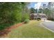 Beautifully landscaped front yard with mature trees surrounding the classic brick home at 2251 Everleigh Ln, Marietta, GA 30064