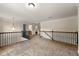 Upstairs hallway with black iron railings, carpeted floors, and views into other rooms at 2251 Everleigh Ln, Marietta, GA 30064