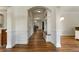 Inviting hallway with hardwood floors, arches and built-in storage leading to dining area at 2251 Everleigh Ln, Marietta, GA 30064