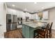 Kitchen with white cabinets, a center island, stainless appliances, and bar stool seating at 2251 Everleigh Ln, Marietta, GA 30064