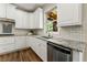 Bright kitchen with white cabinets, granite countertops, and stainless steel dishwasher at 2251 Everleigh Ln, Marietta, GA 30064