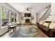Open living room with stone fireplace, hardwood floors, and large windows at 2251 Everleigh Ln, Marietta, GA 30064