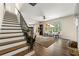 Bright living room features hardwood floors, staircase, large windows with backyard views, and a modern ceiling fan at 2251 Everleigh Ln, Marietta, GA 30064
