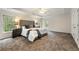 Spacious main bedroom featuring a tray ceiling, carpeted floors, and windows with treeline views at 2251 Everleigh Ln, Marietta, GA 30064