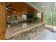 A well-appointed outdoor kitchen with a stone counter, built-in grill, and bar seating, great for hosting and backyard fun at 2251 Everleigh Ln, Marietta, GA 30064