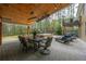 An expansive patio area featuring an outdoor dining area, hot tub, and comfortable lounge seating with backyard views at 2251 Everleigh Ln, Marietta, GA 30064