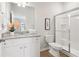 Clean bathroom with granite countertop, shower, white cabinets and modern fixtures at 3623 Squires Park Ln, Loganville, GA 30052