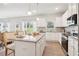 Bright kitchen with white cabinets, granite countertops, and stainless steel appliances at 3623 Squires Park Ln, Loganville, GA 30052