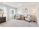 This main bedroom sitting area features two chairs, side table, lamp and a large window at 3623 Squires Park Ln, Loganville, GA 30052