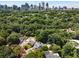 Aerial view of a property showcasing the neighborhood's lush greenery and the Atlanta skyline at 542 Orme Ne Cir, Atlanta, GA 30306