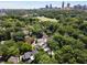 Scenic aerial shot capturing a charming neighborhood with mature trees, showcasing the city skyline at 542 Orme Ne Cir, Atlanta, GA 30306