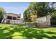 Expansive backyard featuring lush green grass, a modern home, and a separate outbuilding, perfect for outdoor living at 542 Orme Ne Cir, Atlanta, GA 30306