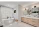 Elegant bathroom with freestanding tub, dual vanities, and a large window at 542 Orme Ne Cir, Atlanta, GA 30306