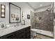 Bathroom featuring a walk-in shower, large vanity, and stylish lighting fixtures at 542 Orme Ne Cir, Atlanta, GA 30306