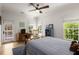 Bedroom with wood floors, a desk, blue bookcase, and multiple windows providing natural light at 542 Orme Ne Cir, Atlanta, GA 30306