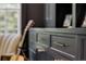 Stylish custom cabinetry with brass hardware and a guitar in the background at 542 Orme Ne Cir, Atlanta, GA 30306