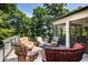 Outdoor deck with cushioned seating surrounding a small coffee table and views of the wooded property at 542 Orme Ne Cir, Atlanta, GA 30306