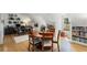 Dining area features a round wooden table, hardwood floors and adjacent office space at 542 Orme Ne Cir, Atlanta, GA 30306