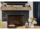 Close-up of the fireplace with a wood mantel, stone surround, and decorative accents at 542 Orme Ne Cir, Atlanta, GA 30306