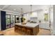 Bright and airy kitchen with a center island, white cabinetry, and access to an outdoor space at 542 Orme Ne Cir, Atlanta, GA 30306