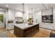 Well-equipped kitchen with a large island, white cabinets, stainless steel appliances, and modern fixtures at 542 Orme Ne Cir, Atlanta, GA 30306