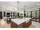Open kitchen and living room featuring a large island, fireplace and dark trimmed windows and doors at 542 Orme Ne Cir, Atlanta, GA 30306