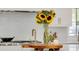 Close-up of the kitchen island with a vase of sunflowers, modern faucet, and stylish décor at 542 Orme Ne Cir, Atlanta, GA 30306