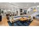 Open-concept living room and kitchen with hardwood floors, a large sofa, and a staircase at 542 Orme Ne Cir, Atlanta, GA 30306