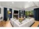 Spacious living room with a fireplace, large sectional sofa, and access to an outdoor patio at 542 Orme Ne Cir, Atlanta, GA 30306