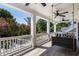 Inviting covered porch featuring a hanging swing with outdoor views and ceiling fans at 542 Orme Ne Cir, Atlanta, GA 30306