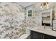 Stylish powder room features designer wallpaper, marble countertop, and modern fixtures at 542 Orme Ne Cir, Atlanta, GA 30306