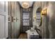 Chic powder room with unique wallpaper, elegant mirror, and modern sink design at 542 Orme Ne Cir, Atlanta, GA 30306