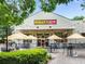 Outdoor dining at restaurant, featuring ample seating, string lights, and vibrant atmosphere at 542 Orme Ne Cir, Atlanta, GA 30306