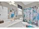Well-lit bathroom with patterned shower curtain, vanity, and decorative wall accents at 705 Sunset Ridge Se Ln, Lawrenceville, GA 30045