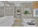 Serene bathroom featuring double sink vanity, soaking tub, and decorative wall art at 705 Sunset Ridge Se Ln, Lawrenceville, GA 30045