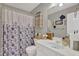 Charming bathroom with floral shower curtain, white vanity, and stylish accents at 705 Sunset Ridge Se Ln, Lawrenceville, GA 30045