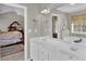 Bright bathroom featuring double sinks, bathtub, shower, and decorative accents at 705 Sunset Ridge Se Ln, Lawrenceville, GA 30045