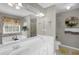 Bright bathroom featuring double sinks, bathtub, shower, and decorative accents at 705 Sunset Ridge Se Ln, Lawrenceville, GA 30045