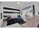 Well-lit bedroom with window, black and white accents, and soft pastel chairs at 705 Sunset Ridge Se Ln, Lawrenceville, GA 30045
