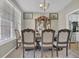 Traditional dining room with elegant china cabinet, dining table, and large windows at 705 Sunset Ridge Se Ln, Lawrenceville, GA 30045