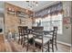 Charming dining room with wood floors, brick accent wall, and rustic decor; great for Gathering gatherings at 705 Sunset Ridge Se Ln, Lawrenceville, GA 30045